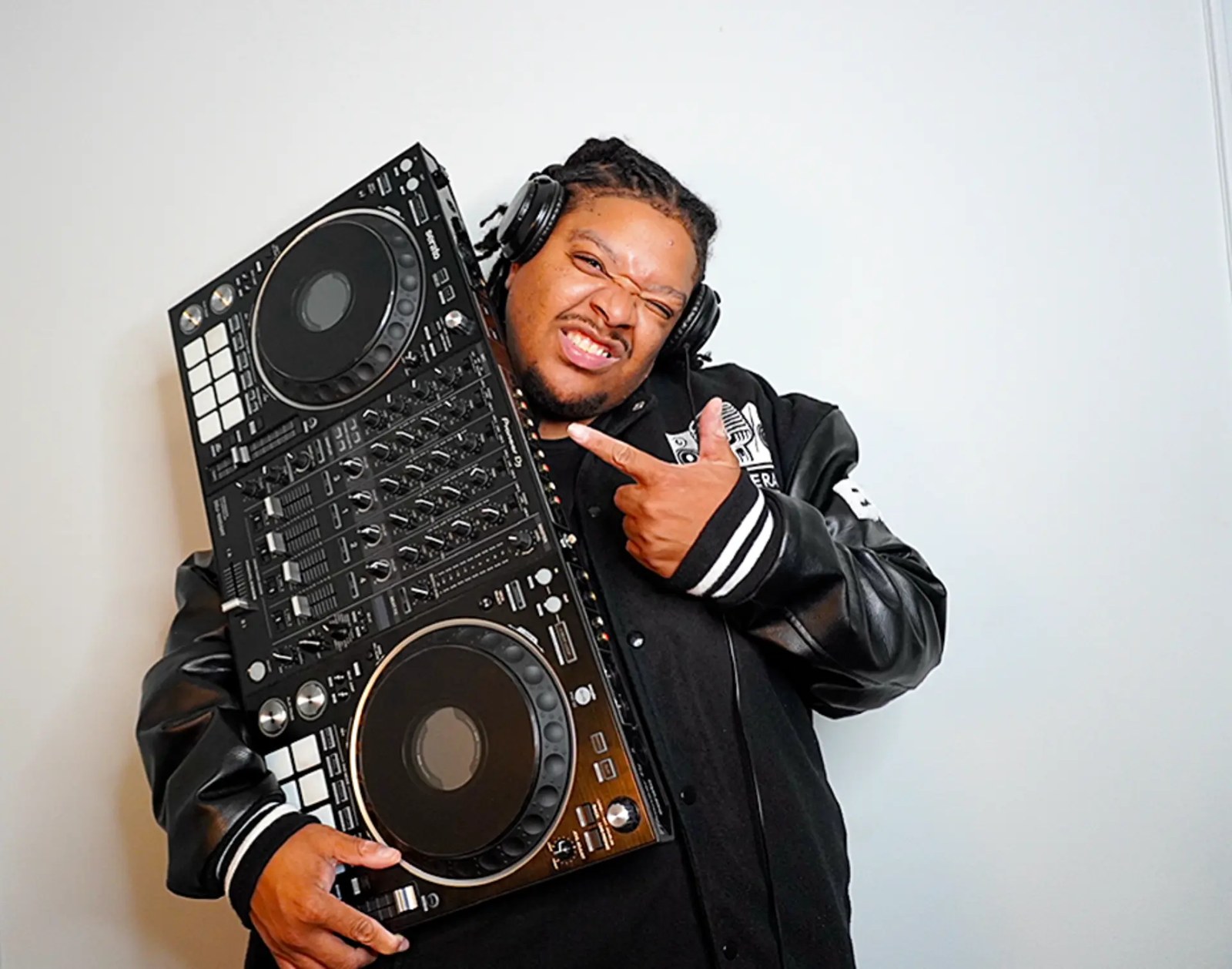 DJ Chase holding a Pioneer DJ controller